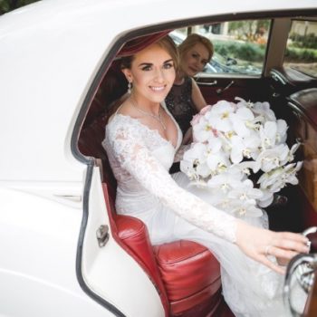 olga in wedding dress getting into a car