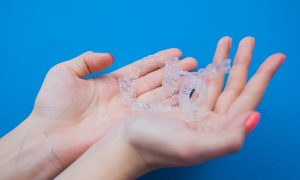 clear aligners in hands