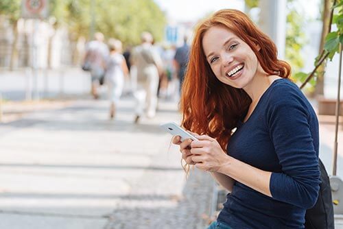 smiling young female patient on phone