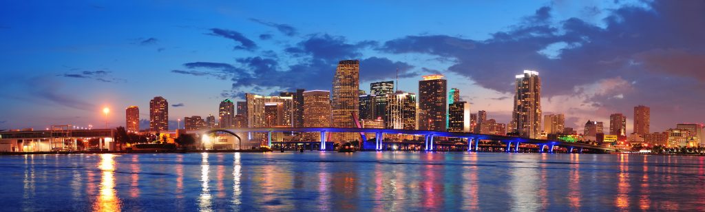 Miami skyline at night with water in the forefront